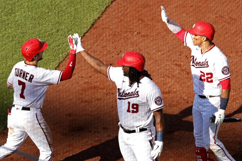 Jun 30, 2021; Washington, District of Columbia, USA; Washington Nationals shortstop Trea Turner (7) celebrates with Nationals first baseman Josh Bell (19) and Nationals left fielder Juan Soto (22) after hitting a home run against the Tampa Bay Rays in the fourth inning at Nationals Park. Mandatory Credit: Geoff Burke-USA TODAY Sports