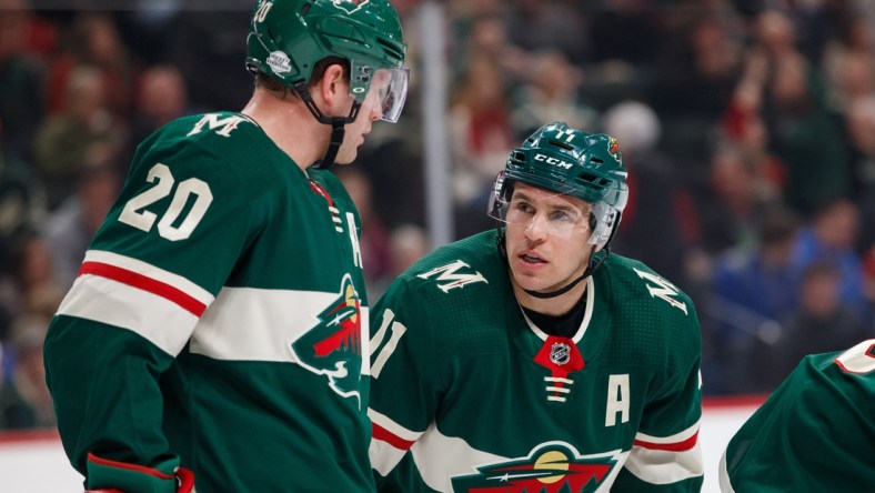 Feb 27, 2018; Saint Paul, MN, USA; Minnesota Wild forward Zach Parise (11) talks to defenseman Ryan Suter (20) in the first period against the St Louis Blues at Xcel Energy Center. Mandatory Credit: Brad Rempel-USA TODAY Sports