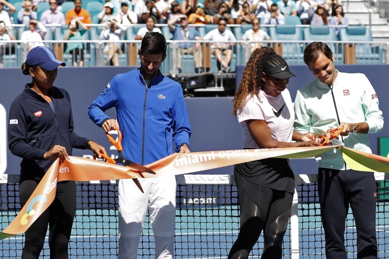 Mar 20, 2019; Miami Gardens, FL, USA; (L-R) Naomi Osaka of Japan, Novak Djokovic of Serbia, Serena Williams of the United States, and Roger Federer of Switzerland participate in a ribbon cutting ceremony on new stadium court at Hard Rock Stadium prior to play in the first round of the Miami Open at Miami Open Tennis Complex. Mandatory Credit: Geoff Burke-USA TODAY Sports