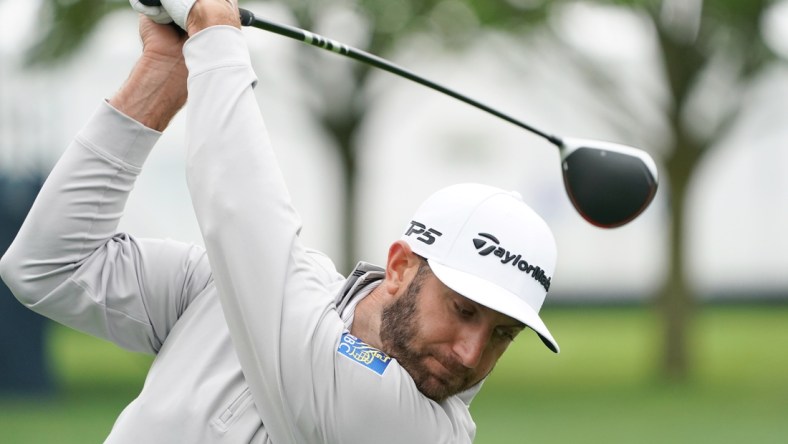 May 13, 2019; Farmingdale, NY, USA; Dustin Johnson practices on the driving range during practice for the PGA Championship golf tournament at Bethpage State Park - Black Course. Mandatory Credit: John David Mercer-USA TODAY Sports