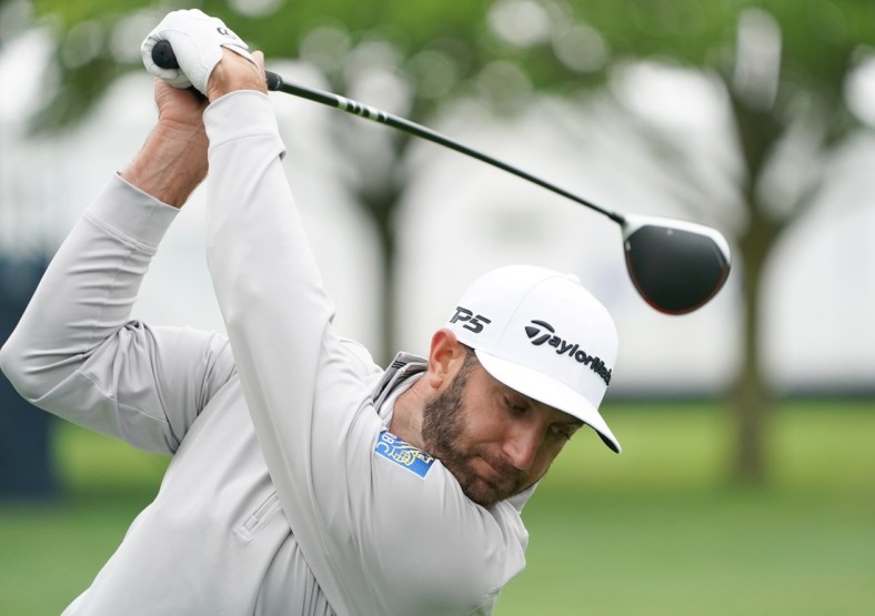 May 13, 2019; Farmingdale, NY, USA; Dustin Johnson practices on the driving range during practice for the PGA Championship golf tournament at Bethpage State Park - Black Course. Mandatory Credit: John David Mercer-USA TODAY Sports
