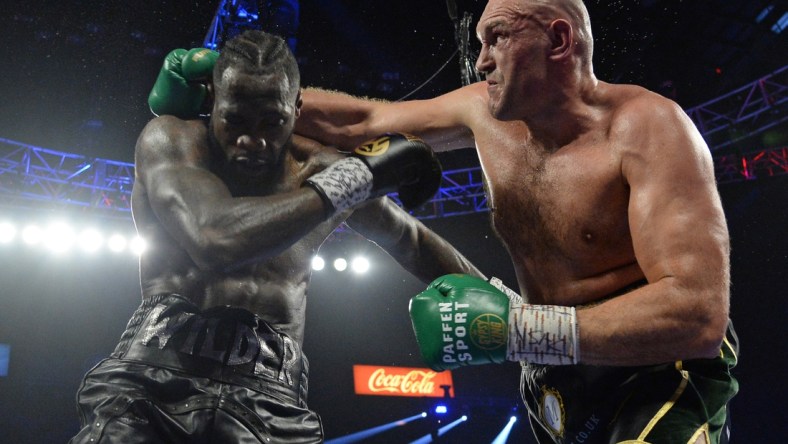 Feb 22, 2020; Las Vegas, Nevada, USA; Deontay Wilder and Tyson Fury box during their WBC heavyweight title bout at MGM Grand Garden Arena. Fury won via seventh round TKO. Mandatory Credit: Joe Camporeale-USA TODAY Sports