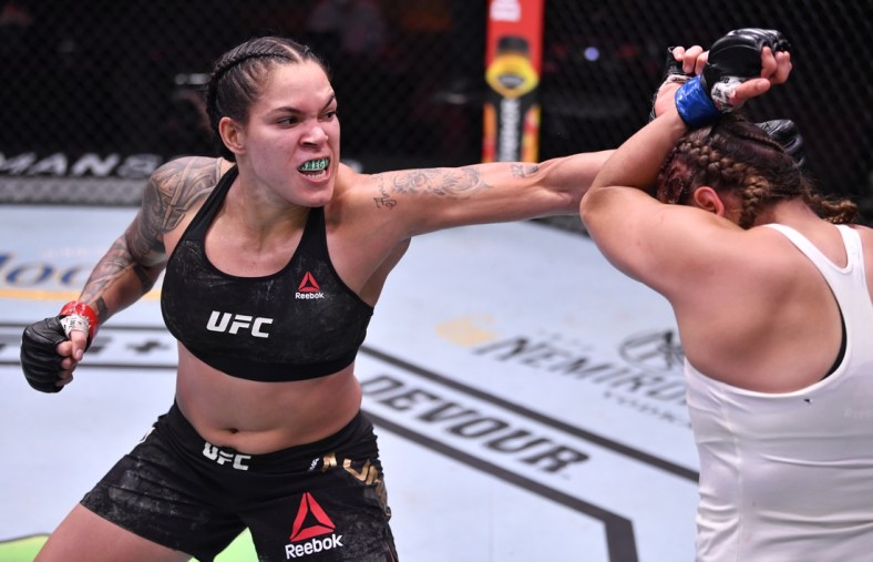 June 6, 2020; Las Vegas, NV, USA; Amanda Nunes of Brazil punches Felicia Spencer of Canada in their UFC featherweight championship bout  during UFC 250 at the UFC APEX.  Mandatory Credit: Jeff Bottari/Zuffa LLC via USA TODAY Sports