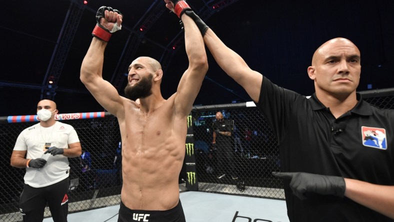 July 26, 2020; Abu Dhabi, UAE; Khamzat Chimaev (red gloves) of Czechia celebrates after his TKO victory over Rhys McKee (not pictured) of Northern Ireland in their welterweight fight during the UFC Fight Night event inside Flash Forum on UFC Fight Island .  Mandatory Credit: Jeff Bottari/Zuffa LLC via USA TODAY Sports