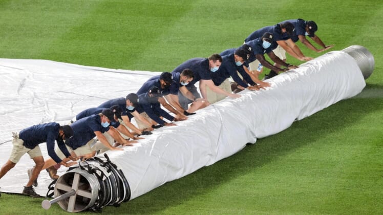 Aug 17, 2020; Bronx, New York, USA; Grounds crew covers the field for a rain delay during the top of the fourth inning of the game between the New York Yankees and the Boston Red Sox at Yankee Stadium. Mandatory Credit: Vincent Carchietta-USA TODAY Sports