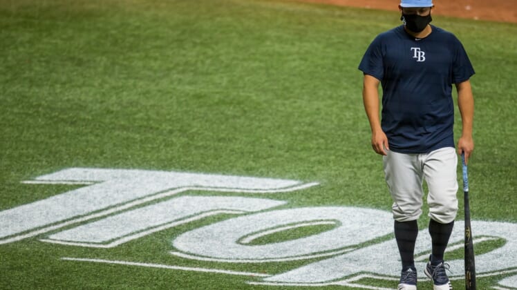 Aug 21, 2020; St. Petersburg, Florida, USA;  Tampa Bay Rays designated hitter Yoshitomo Tsutsugo (25) crosses the Tropicana logo during batting practice before a game against the Toronto Blue Jays at Tropicana Field. Mandatory Credit: Mary Holt-USA TODAY Sports