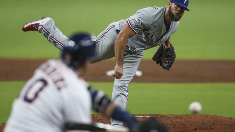 Sep 1, 2020; Houston,Texas, USA; Texas Rangers relief pitcher Luis Garcia (45) delivers a pitch to Houston Astros first baseman Yuli Gurriel (10) during the first inning at Minute Maid Park. Mandatory Credit: Troy Taormina-USA TODAY Sports