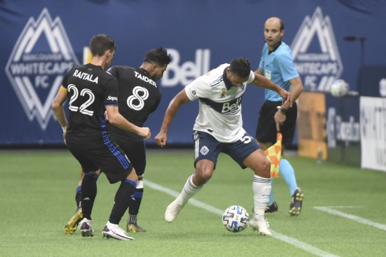 Sep 16, 2020; Vancouver, British Columbia, CAN;  Montreal Impact defender Jukka Raitala (22) and midfielder Saphir Taider (8) defend against Vancouver Whitecaps defender Ali Adnan (53) during the second half at BC Place. Mandatory Credit: Anne-Marie Sorvin-USA TODAY Sports