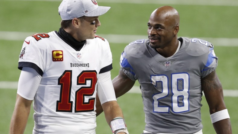 Dec 26, 2020; Detroit, Michigan, USA; Detroit Lions running back Adrian Peterson (28) talks with Tampa Bay Buccaneers quarterback Tom Brady (12) after the game at Ford Field. Mandatory Credit: Raj Mehta-USA TODAY Sports