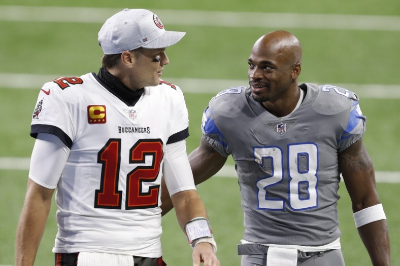 Dec 26, 2020; Detroit, Michigan, USA; Detroit Lions running back Adrian Peterson (28) talks with Tampa Bay Buccaneers quarterback Tom Brady (12) after the game at Ford Field. Mandatory Credit: Raj Mehta-USA TODAY Sports