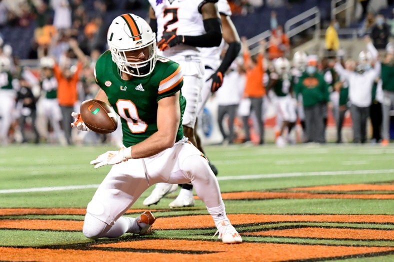 Dec 29, 2020; Orlando, FL, USA; Miami Hurricanes wide receiver Marshall Few (0) reacts after running the ball in for a two-point conversion during the second half against the Oklahoma State Cowboys during the Cheez-It Bowl Game at Camping World Stadium. Mandatory Credit: Douglas DeFelice-USA TODAY Sports