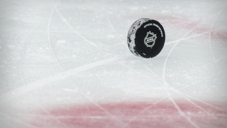 Jan 26, 2021; Dallas, Texas, USA; A view of a puck and the NHL logo and the face-off circle before the game between the Dallas Stars and the Detroit Red Wings at the American Airlines Center. Mandatory Credit: Jerome Miron-USA TODAY Sports