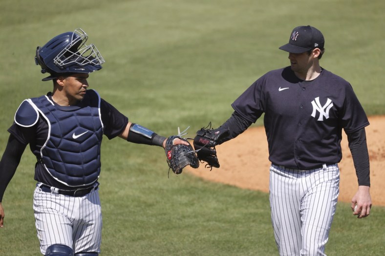 Feb 26, 2021; Tampa, Florida, USA;  New York Yankees starting pitcher Jordan Montgomery (47) and catcher Robinson Chirinos (61) talk after pitching during spring training workouts at George M. Steinbrenner Field Mandatory Credit: Kim Klement-USA TODAY Sports