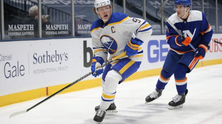Mar 4, 2021; Uniondale, New York, USA; Buffalo Sabres center Jack Eichel (9) plays the puck against New York Islanders defenseman Ryan Pulock (6) during the first period at Nassau Veterans Memorial Coliseum. Mandatory Credit: Brad Penner-USA TODAY Sports