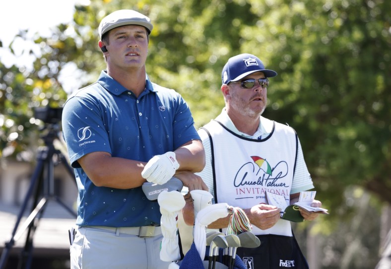 Mar 5, 2021; Orlando, Florida, USA;  Bryson DeChambeau (left) and his caddie Tim Tucker look doiwn the first fairway before the second round of the Arnold Palmer Invitational golf tournament at Bay Hill Club & Lodge. Mandatory Credit: Reinhold Matay-USA TODAY Sports