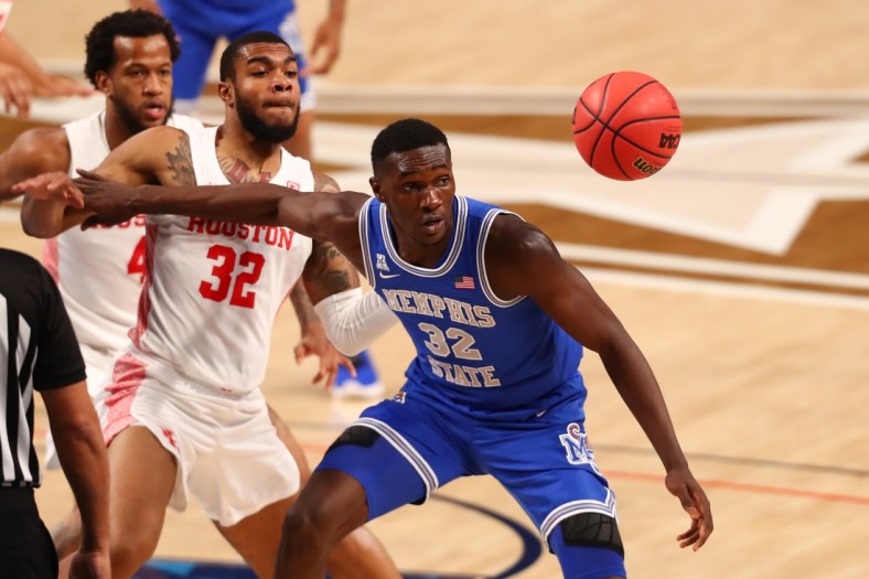 Mar 13, 2021; Fort Worth, TX, USA; Memphis Tigers center Moussa Cisse (32) tracks down a loose ball against Houston Cougars forward Reggie Chaney (32) during the first half at Dickies Arena. Mandatory Credit: Ben Ludeman-USA TODAY Sports