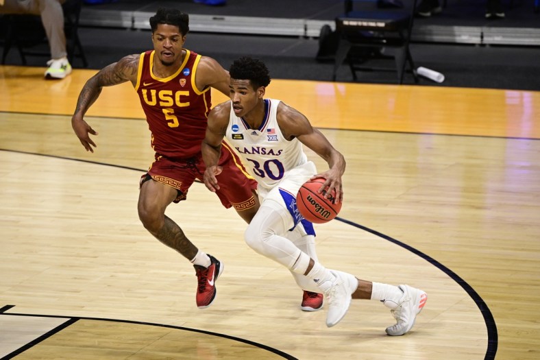 Mar 22, 2021; Indianapolis, Indiana, USA; Kansas Jayhawks guard Ochai Agbaji (30) drives to the basket whle Southern California Trojans guard Isaiah White (5) defends during the second half in the second round of the 2021 NCAA Tournament at Hinkle Fieldhouse. Mandatory Credit: Marc Lebryk-USA TODAY Sports