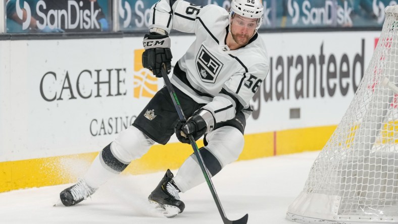 Mar 24, 2021; San Jose, California, USA;  Los Angeles Kings defenseman Kurtis MacDermid (56) controls the puck during the first period against the San Jose Sharks at SAP Center at San Jose. Mandatory Credit: Stan Szeto-USA TODAY Sports