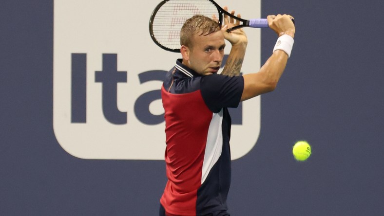 Mar 26, 2021; Miami, Florida, USA; Daniel Evans of Great Britain hits a backhand against Frances Tiafoe of the United States (not pictured) in the second round in the Miami Open at Hard Rock Stadium. Mandatory Credit: Geoff Burke-USA TODAY Sports