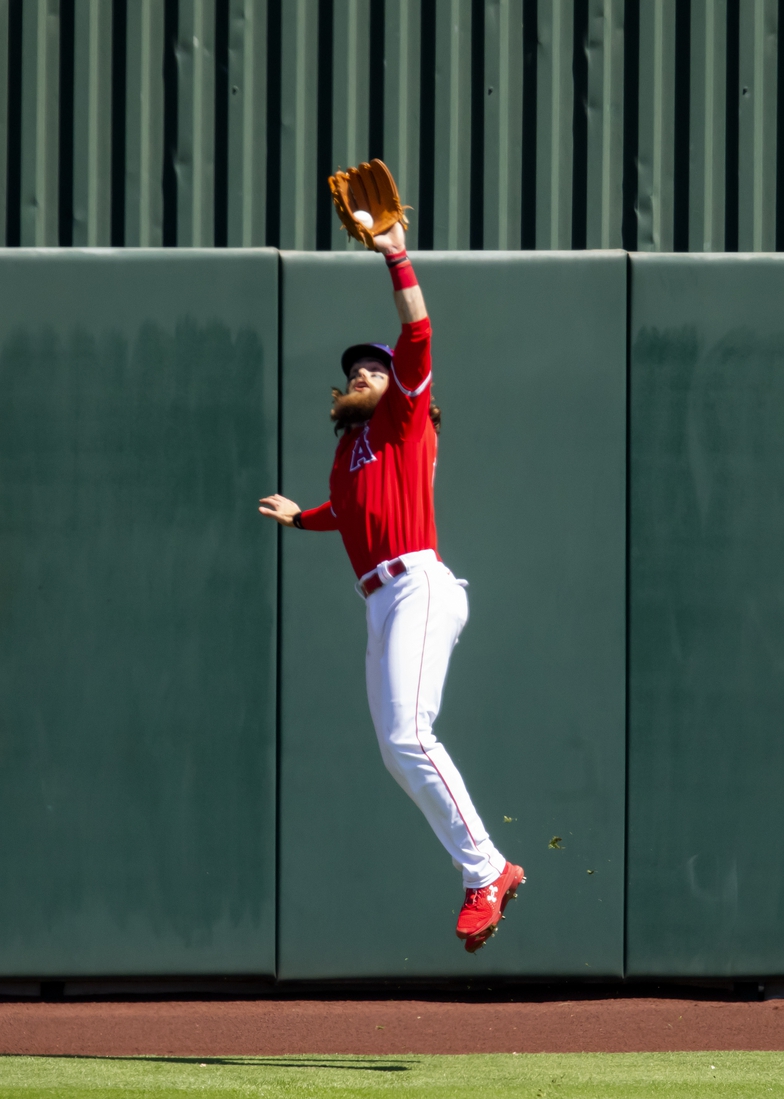 Mar 27, 2021; Tempe, Arizona, USA; Los Angeles Angels outfielder Brandon Marsh makes a leaping catch against the wall against the San Diego Padres during a Spring Training game at Tempe Diablo Stadium. Mandatory Credit: Mark J. Rebilas-USA TODAY Sports