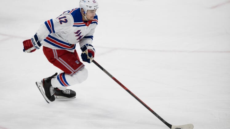 Mar 28, 2021; Washington, District of Columbia, USA; New York Rangers right wing Julien Gauthier (12) skates with the puck against the Washington Capitals during the first period at Capital One Arena. Mandatory Credit: Scott Taetsch-USA TODAY Sports