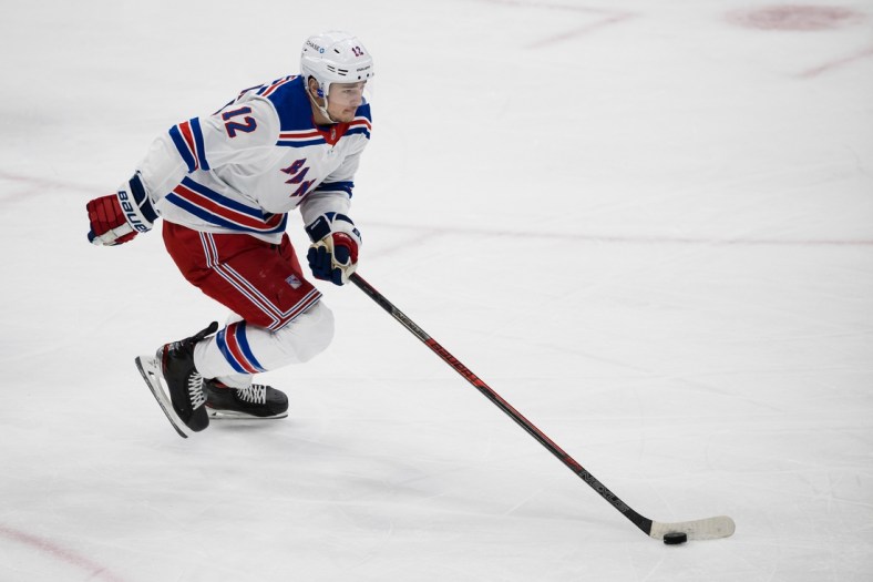 Mar 28, 2021; Washington, District of Columbia, USA; New York Rangers right wing Julien Gauthier (12) skates with the puck against the Washington Capitals during the first period at Capital One Arena. Mandatory Credit: Scott Taetsch-USA TODAY Sports