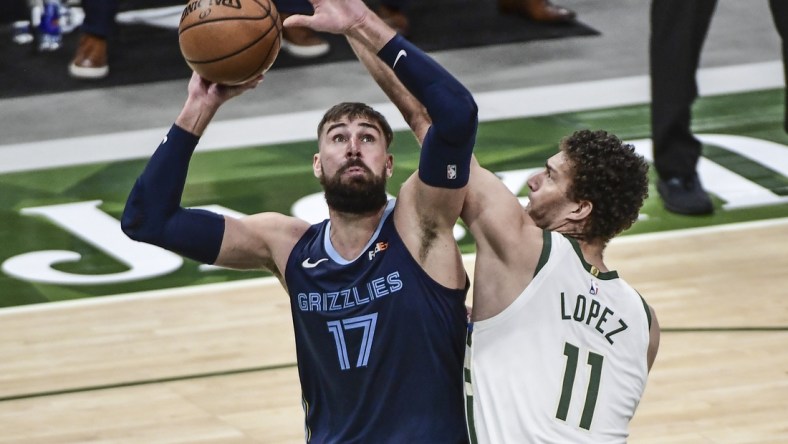 Apr 17, 2021; Milwaukee, Wisconsin, USA; Memphis Grizzlies center Jonas Valanciunas (17) takes a shot against Milwaukee Bucks center Brook Lopez (11) in the third quarter at Fiserv Forum. Mandatory Credit: Benny Sieu-USA TODAY Sports