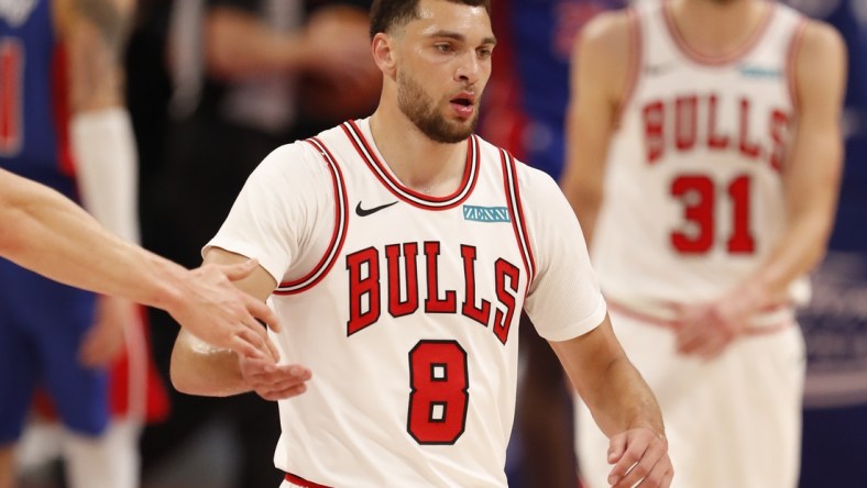 May 9, 2021; Detroit, Michigan, USA; Chicago Bulls guard Zach LaVine (8) gives five to a teammate as he walks to the bench during the second quarter against the Detroit Pistons at Little Caesars Arena. Mandatory Credit: Raj Mehta-USA TODAY Sports