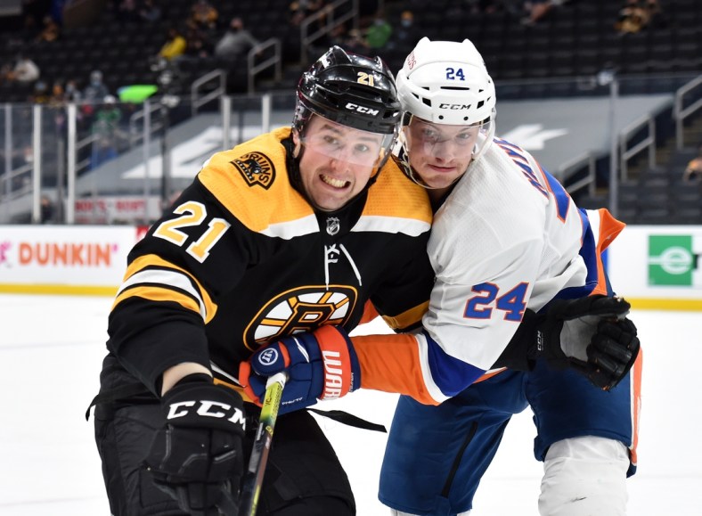 May 10, 2021; Boston, Massachusetts, USA;  Boston Bruins left wing Nick Ritchie (21) and New York Islanders defenseman Nick Leddy (2) battle for position during the second period at TD Garden. Mandatory Credit: Bob DeChiara-USA TODAY Sports