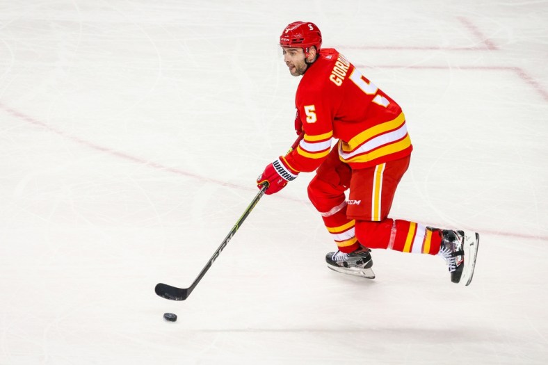 May 5, 2021; Calgary, Alberta, CAN; Calgary Flames defenseman Mark Giordano (5) skates with the puck against the Winnipeg Jets during the third period at Scotiabank Saddledome. Mandatory Credit: Sergei Belski-USA TODAY Sports