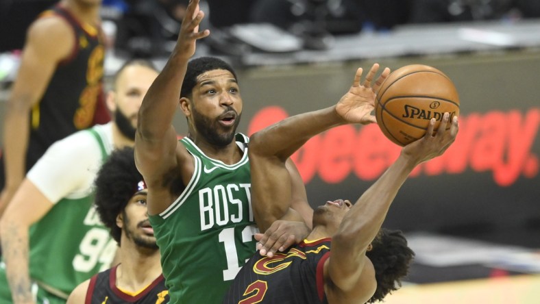 May 12, 2021; Cleveland, Ohio, USA; Boston Celtics center Tristan Thompson (13) defends Cleveland Cavaliers guard Collin Sexton (2) in the third quarter at Rocket Mortgage FieldHouse. Mandatory Credit: David Richard-USA TODAY Sports