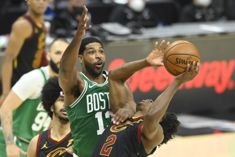 May 12, 2021; Cleveland, Ohio, USA; Boston Celtics center Tristan Thompson (13) defends Cleveland Cavaliers guard Collin Sexton (2) in the third quarter at Rocket Mortgage FieldHouse. Mandatory Credit: David Richard-USA TODAY Sports