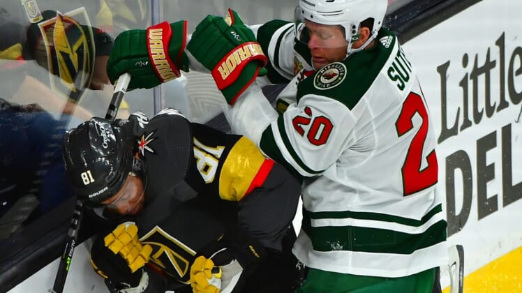 May 18, 2021; Las Vegas, Nevada, USA; Minnesota Wild defenseman Ryan Suter (20) hits Vegas Golden Knights center Jonathan Marchessault (81) during the first period of game two of the first round of the 2021 Stanley Cup Playoffs at T-Mobile Arena. Mandatory Credit: Stephen R. Sylvanie-USA TODAY Sports