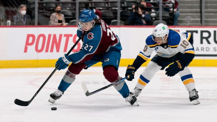 May 19, 2021; Denver, Colorado, USA; Colorado Avalanche defenseman Ryan Graves (27) controls the puck under pressure from St. Louis Blues center Brayden Schenn (10) in the third period in game two of the first round of the 2021 Stanley Cup Playoffs at Ball Arena. Mandatory Credit: Isaiah J. Downing-USA TODAY Sports