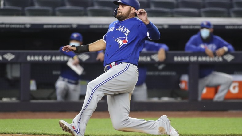 May 25, 2021; Bronx, New York, USA; Toronto Blue Jays designated hitter Rowdy Tellez (44) starts sliding into home plate in the seventh inning against the New York Yankees at Yankee Stadium. Mandatory Credit: Wendell Cruz-USA TODAY Sports