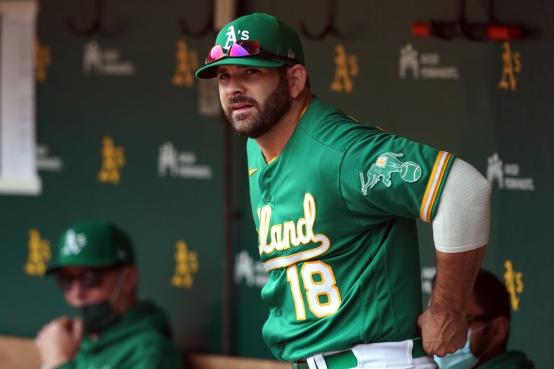 May 29, 2021; Oakland, California, USA; Oakland Athletics designated hitter Mitch Moreland (18) stands in the dugout before a game against the Los Angeles Angels at RingCentral Coliseum. Mandatory Credit: Darren Yamashita-USA TODAY Sports