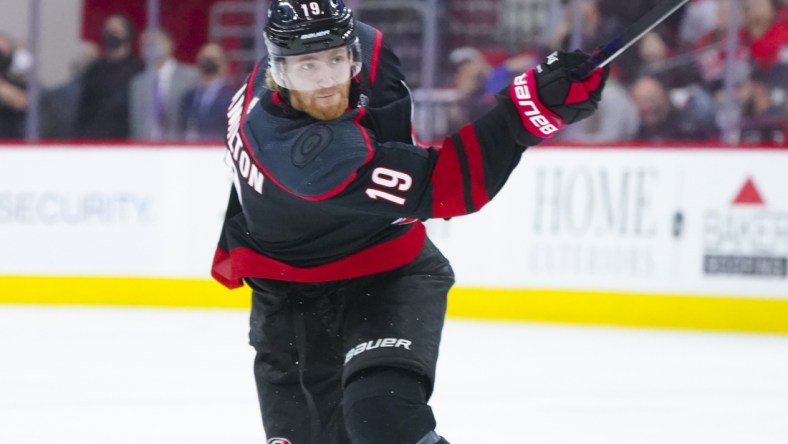 May 30, 2021; Raleigh, North Carolina, USA; Carolina Hurricanes defenseman Dougie Hamilton (19) takes a shot against the Tampa Bay Lightning in game one of the second round of the 2021 Stanley Cup Playoffs at PNC Arena. Mandatory Credit: James Guillory-USA TODAY Sports