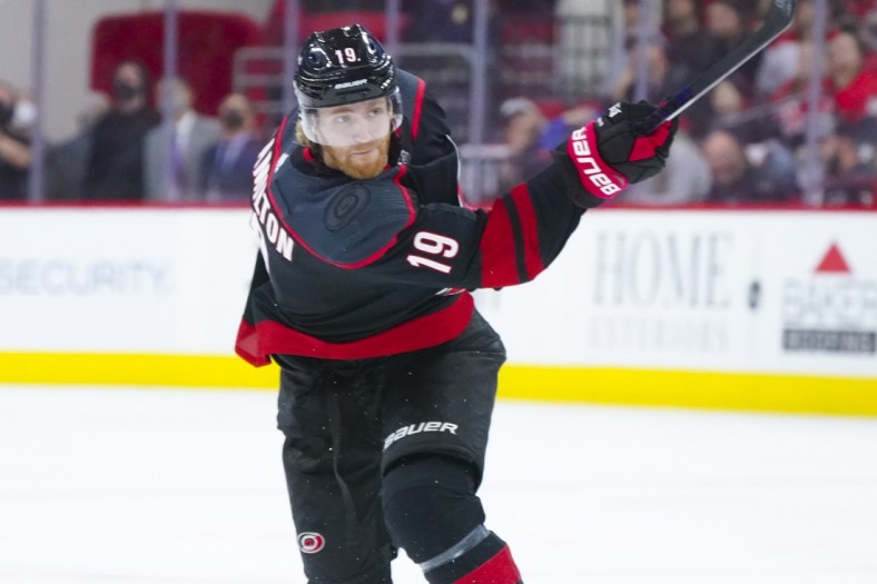 May 30, 2021; Raleigh, North Carolina, USA; Carolina Hurricanes defenseman Dougie Hamilton (19) takes a shot against the Tampa Bay Lightning in game one of the second round of the 2021 Stanley Cup Playoffs at PNC Arena. Mandatory Credit: James Guillory-USA TODAY Sports
