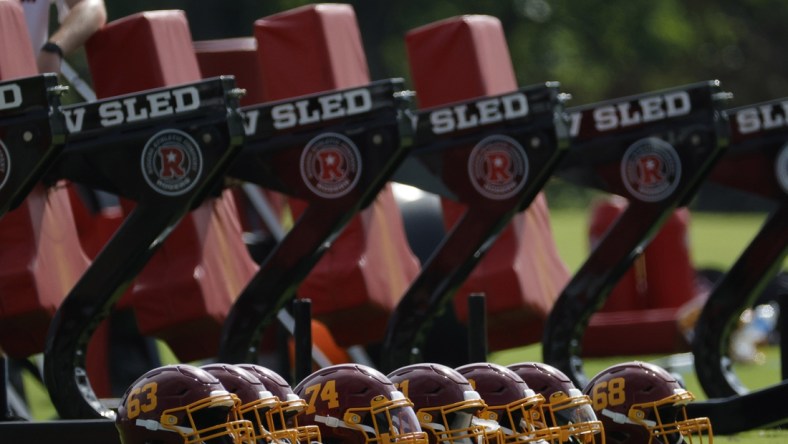 Jun 10, 2021; Ashburn, VA, USA; A view of Washington Football Team players' helmets resting on the field prior to drills as part of minicamp at Inova Sports Performance Center. Mandatory Credit: Geoff Burke-USA TODAY Sports