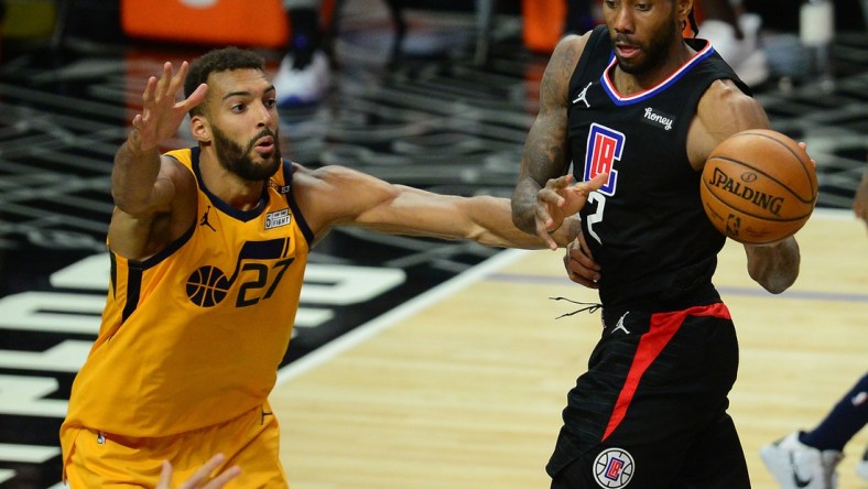 Jun 14, 2021; Los Angeles, California, USA; Los Angeles Clippers forward Kawhi Leonard (2) passes the ball against Utah Jazz center Rudy Gobert (27) during the second half in game four in the second round of the 2021 NBA Playoffs. at Staples Center. Mandatory Credit: Gary A. Vasquez-USA TODAY Sports