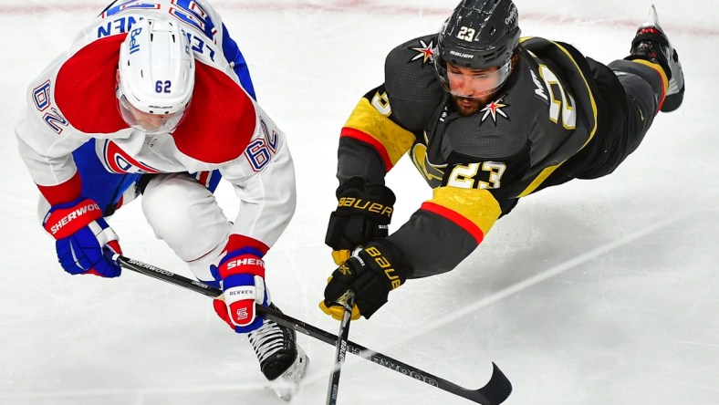 Jun 16, 2021; Las Vegas, Nevada, USA;Vegas Golden Knights defenseman Alec Martinez (23) dives to tip a puck away from the reach of Montreal Canadiens left wing Artturi Lehkonen (62) during the second period of game two of the 2021 Stanley Cup Semifinals at T-Mobile Arena. Mandatory Credit: Stephen R. Sylvanie-USA TODAY Sports