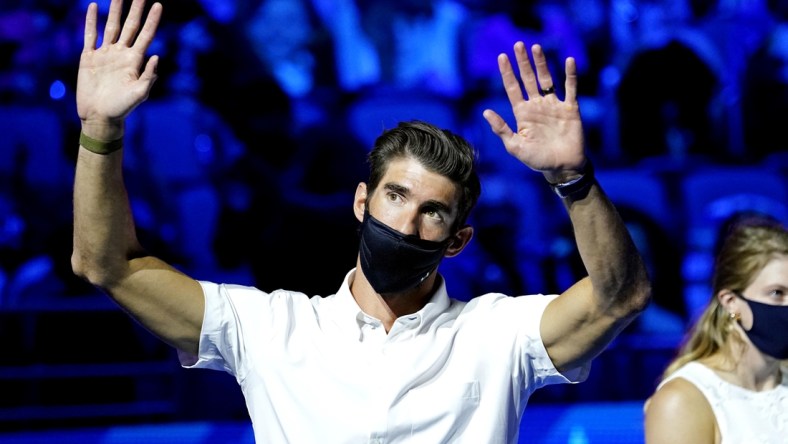 Jun 18, 2021; Omaha, Nebraska, USA; Michael Phelps waves to the crowd during the Medal Ceremony during the U.S. Olympic Team Trials Swimming competition at CHI Health Center Omaha. Mandatory Credit: Rob Schumacher-USA TODAY Sports