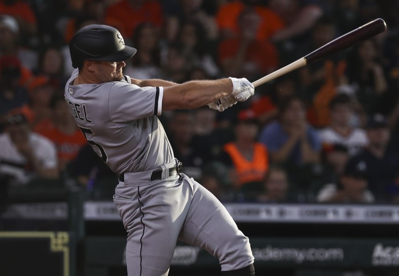 Jun 19, 2021; Houston, Texas, USA; Chicago White Sox center fielder Adam Engel (15) hits a single during the third inning against the Houston Astros at Minute Maid Park. Mandatory Credit: Troy Taormina-USA TODAY Sports