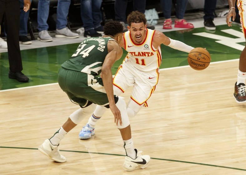 Jun 23, 2021; Milwaukee, Wisconsin, USA;  Atlanta Hawks guard Trae Young (11) drives for the basket against Milwaukee Bucks forward Giannis Antetokounmpo (34) during the fourth quarter during game one of the Eastern Conference Finals for the 2021 NBA Playoffs at Fiserv Forum. Mandatory Credit: Jeff Hanisch-USA TODAY Sports