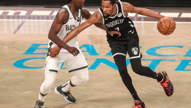 Jun 19, 2021; Brooklyn, New York, USA; Milwaukee Bucks  guard Jrue Holiday (21) and Brooklyn Nets forward Kevin Durant (7) during game seven in the second round of the 2021 NBA Playoffs at Barclays Center. Mandatory Credit: Wendell Cruz-USA TODAY Sports