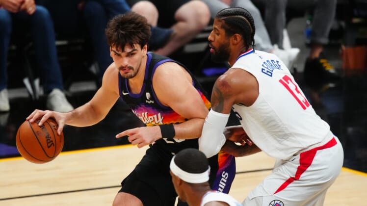 Jun 22, 2021; Phoenix, Arizona, USA; Phoenix Suns forward Dario Saric (left) against Los Angeles Clippers guard Paul George during game two of the Western Conference Finals for the 2021 NBA Playoffs at Phoenix Suns Arena. Mandatory Credit: Mark J. Rebilas-USA TODAY Sports