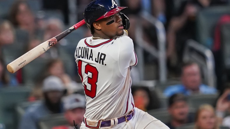 Jun 29, 2021; Cumberland, Georgia, USA; Atlanta Braves right fielder Ronald Acuna Jr. (13) singles against the New York Mets during the fifth inning at Truist Park. Mandatory Credit: Dale Zanine-USA TODAY Sports