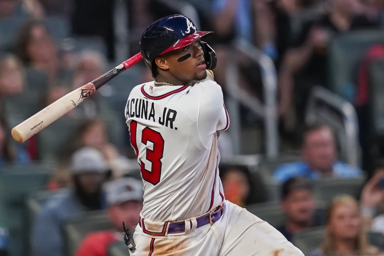Jun 29, 2021; Cumberland, Georgia, USA; Atlanta Braves right fielder Ronald Acuna Jr. (13) singles against the New York Mets during the fifth inning at Truist Park. Mandatory Credit: Dale Zanine-USA TODAY Sports
