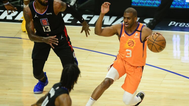 Jun 30, 2021; Los Angeles, California, USA; Phoenix Suns guard Chris Paul (3) controls the ball against Los Angeles Clippers guard Paul George (13) during the first half in game six of the Western Conference Finals for the 2021 NBA Playoffs at Staples Center. Mandatory Credit: Gary A. Vasquez-USA TODAY Sports