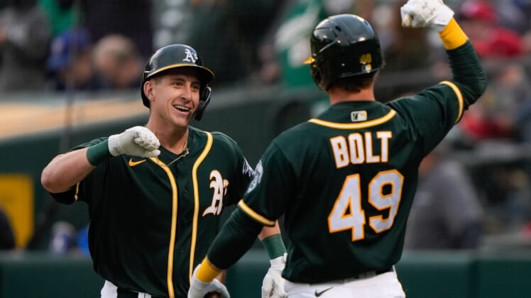 Jun 30, 2021; Oakland, California, USA;  Oakland Athletics designated hitter Frank Schwindel (45) celebrates with center fielder Skye Bolt (49) after hitting a two-run home run during the second inning against the Texas Rangers at RingCentral Coliseum. Mandatory Credit: Stan Szeto-USA TODAY Sports